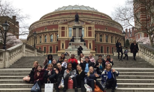 Group photo of the school choir sat on the steps outside The Royal Albert Hall